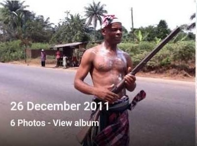 A man fully dressed with his akwa george and nzu carrying "egbe ntu".