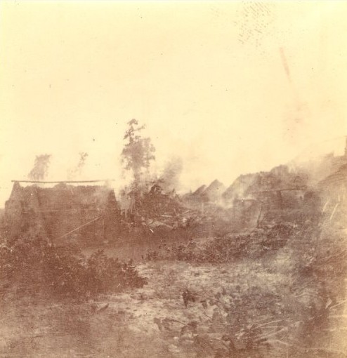 “Burning Arochuku”. A photo taken in what shortly became Southern Nigeria during The Aro Punitive Expedition of 1901 in which British African troops and their British commanders invaded the heart of the Aro Confederacy at Arochukwu.