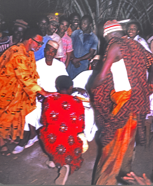 Acolyte kneels before Igwe