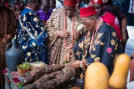 Igbo elders at a New Yam Festival with yams displayed