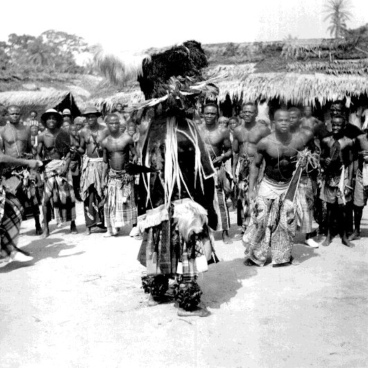 Black and white photo of Igbo men in Ekpeya festival dance”
