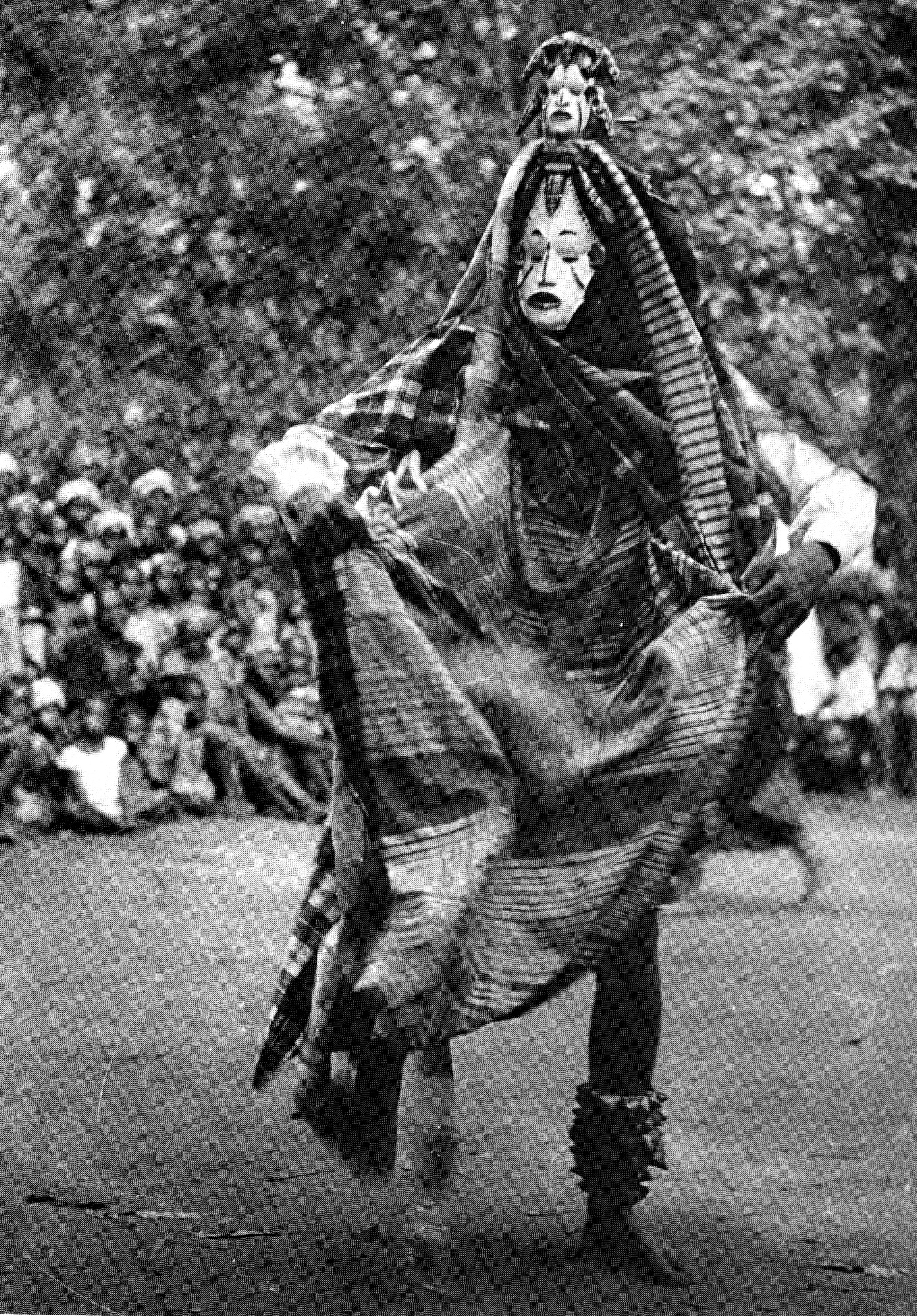 Archival black-and-white photograph of Igbo masquerade performance.”
