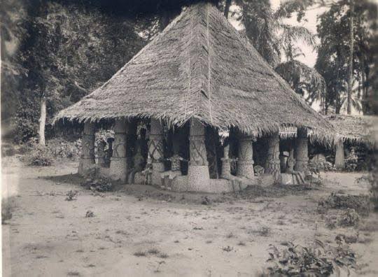 Archival black-and-white photograph showing extended Igbo family compound.
