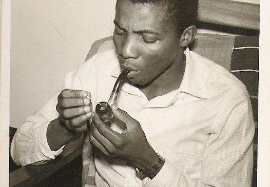 Christopher Okigbo smoking a cigarette, 1960s portrait — Nigerian poet known for his lyrical intensity and political consciousness.