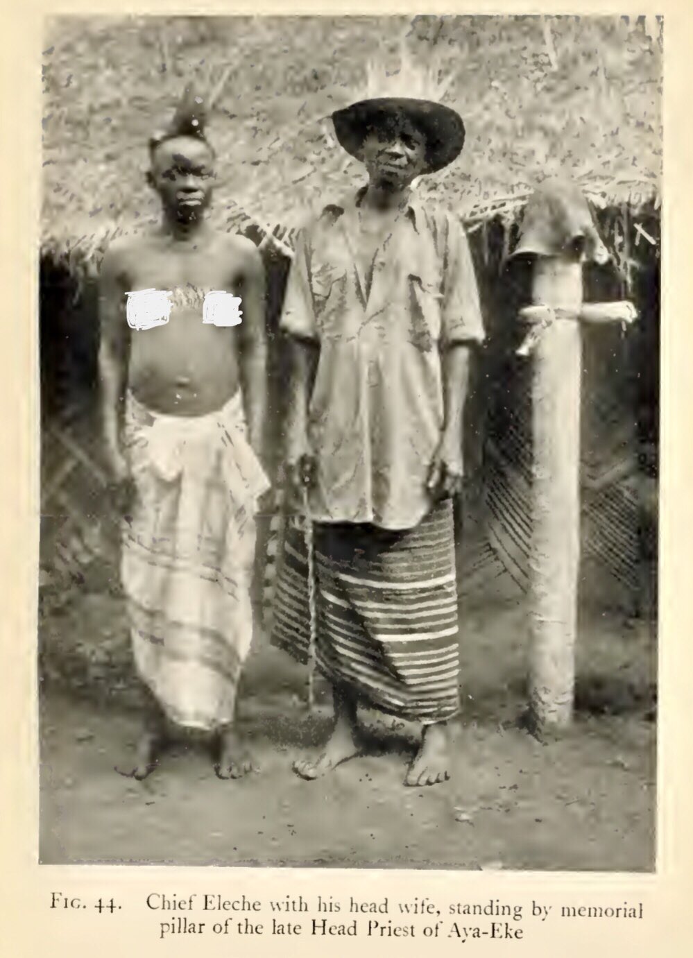 Chief Eleche (Elechi) of Elele stands with his head wife beside the memorial pillar honouring the late Head Priest of Aya-Eke. Photograph taken in 1914 in what is now Ikwerre LGA, Rivers State, was later documented in Some of Nigeria’s Fertility Cults (1927) by P. A. Talbot.”