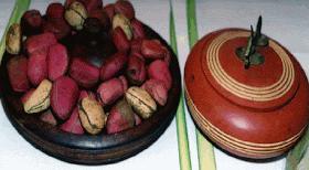 Kola nut displayed in traditional Igbo wooden plate.