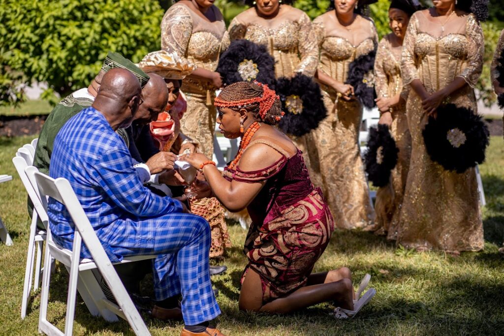 Bride Kneeling in front of her dad during the Wine-Carrying-Ceremony-Traditional-Igbo-Wedding.
