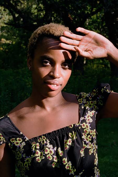 Chioma Ebinama standing outdoors, wearing a floral dress