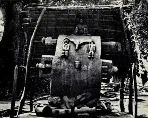 Man sitting and playing an Ikoro Drum Source: mongst the Igbos, G.T Basden (1921) 