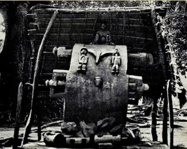 Man sitting and playing an Ikoro Drum Source: mongst the Igbos, G.T Basden (1921)